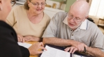 elderly couple reviewing financial documents elderly couple reviewing financial documents