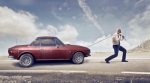 Man dragging broken car Man dragging broken car