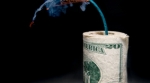 Roll of money with lit fuse Roll of money with lit fuse