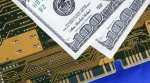 hundred dollar bills on a computer circuit hundred dollar bills on a computer circuit