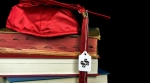 Graduation cap on textbooks Graduation cap on textbooks