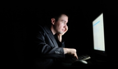 Man viewing computer in the dark Man viewing computer in the dark