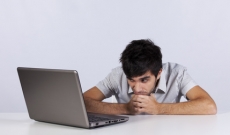 Student staring at laptop Student staring at laptop