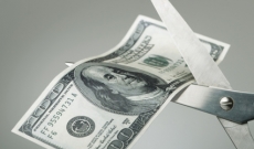 hundred dollar bill being cut by scissors hundred dollar bill being cut by scissors