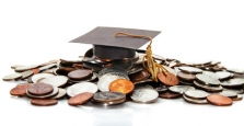 Graduation cap on pile of change Graduation cap on pile of change