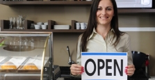 Small business owner holding open sign Small business owner holding open sign
