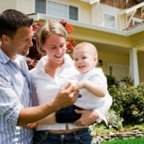 family standing in front of new house