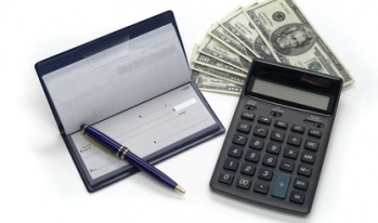Check book, calculator, and money stack Check book, calculator, and money stack