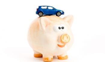 Car sitting on a piggy bank Car sitting on a piggy bank