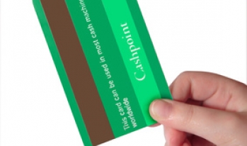 Holding credit card Hand holding green credit card