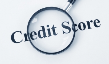 Magnifying glass over words "Credit Score" Magnifying glass over words "Credit Score"