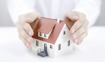 Two hands covering a home Two hands covering a home