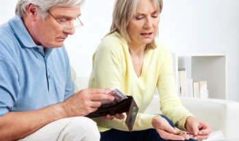 Older couple reviewing money Older couple reviewing money