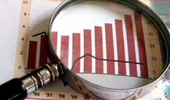 Review Graph Magnifying glass hovering over rising graph