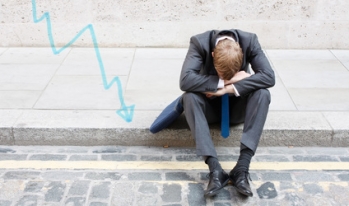 Stock broker sitting on curb Stock broker sitting on curb