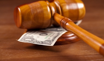 Arbitration gavel resting on money Arbitration gavel resting on money