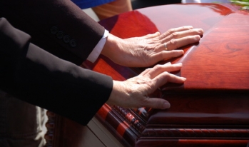 Hands on a casket Hands on a casket