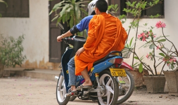 Monk riding motorbike in Thailand Monk riding motorbike in Thailand