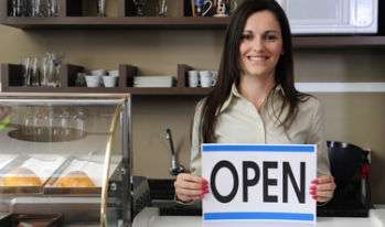 Small business owner holding open sign Small business owner holding open sign