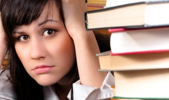 Stressed student with text books Stressed student with text books