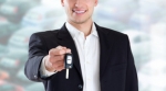 Smiling salesman with keys to new car Smiling salesman with keys to new car