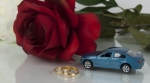 Car, rose, and wedding rings Car, rose, and wedding rings