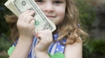 little girl holding cash money little girl holding cash money