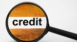 Magnifying glass looking at credit Magnifying glass looking at credit