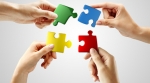Multiple hands putting puzzle pieces together Multiple hands putting puzzle pieces together