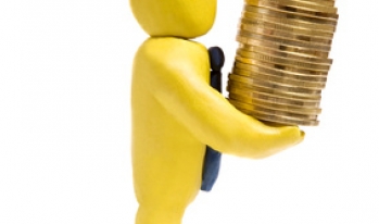 Toy banker holding a stack of coins Toy banker holding a stack of coins