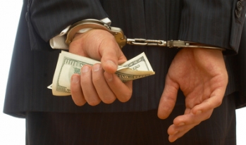Businessman with cash and handcuffs Businessman with cash and handcuffs