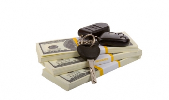 Keys on money stack Keys sitting on stack of money