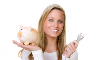 Woman holding piggy bank and power cord Woman holding piggy bank and power cord