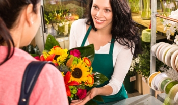 Female florist selling flowers Female florist selling flowers