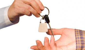 Exchanging keys Two hands exchanging keys