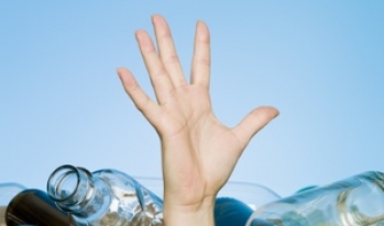Hand reaching out liquor bottles Hand reaching out liquor bottles