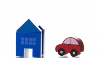 Toy car and toy house Small toy car next to toy house