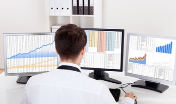 Man trading stocks on computer Man trading stocks on computer