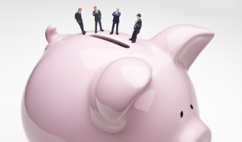 Tiny lenders on top of piggy bank Tiny lenders on top of piggy bank