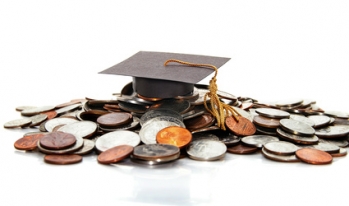 Graduation cap on pile of change Graduation cap on pile of change