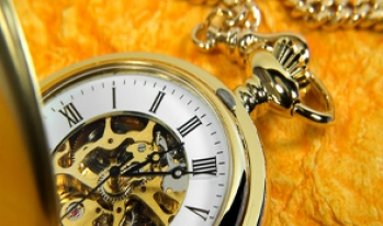 Stopwatch sitting on gold background Stopwatch sitting on gold background