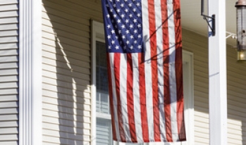 American flag hanging in front of a home American flag hanging in front of a home
