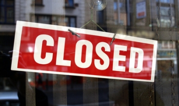 closed sign in front of a business closed sign in front of a business