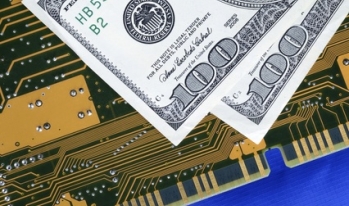 hundred dollar bills on a computer circuit hundred dollar bills on a computer circuit