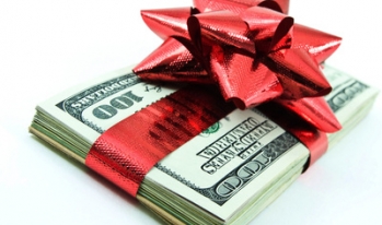Money wrapped with ribbon and bow Money wrapped with ribbon and bow