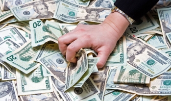 a hand grabbing money a hand grabbing money