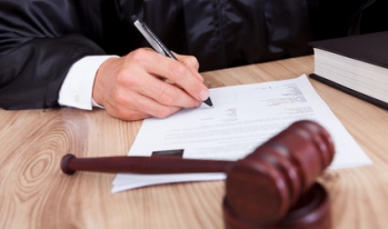 judge with a gavel signing papers judge with a gavel signing papers