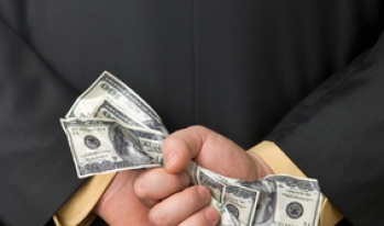 politician with money behind his back politician with money behind his back