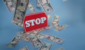 stop sign with dollars falling from the sky stop sign with dollars falling from the sky
