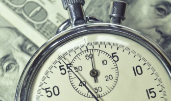a stopwatch on a one hundred dollar bill a stopwatch on a one hundred dollar bill